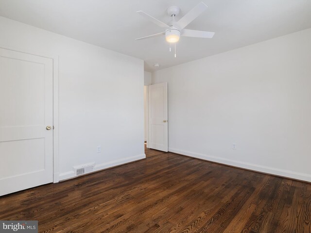 spare room with ceiling fan and dark wood-type flooring