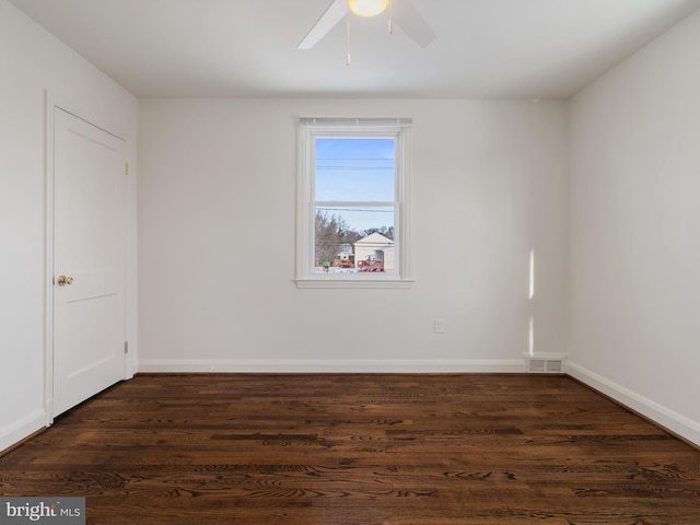 spare room featuring ceiling fan and dark hardwood / wood-style flooring