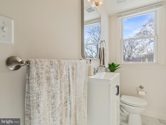 bathroom featuring toilet and vanity