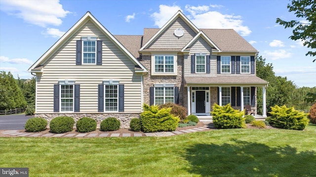 view of front of property featuring a front lawn and covered porch