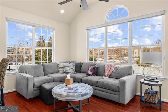 living room featuring lofted ceiling, ceiling fan, dark hardwood / wood-style flooring, and a healthy amount of sunlight