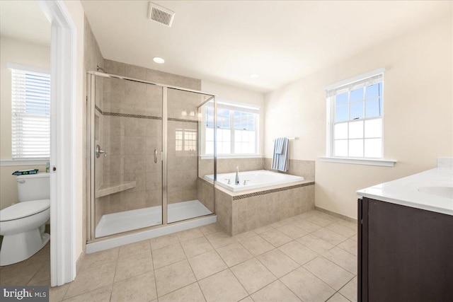 full bathroom featuring tile patterned flooring, vanity, plus walk in shower, and toilet