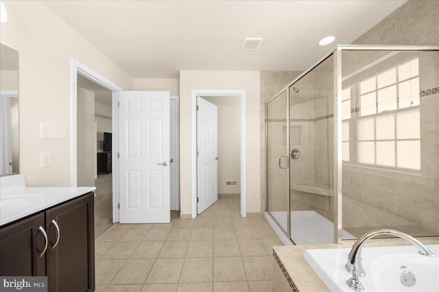 bathroom with vanity, tile patterned flooring, and shower with separate bathtub