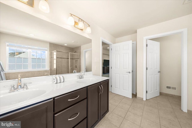 bathroom featuring vanity, tile patterned floors, and walk in shower