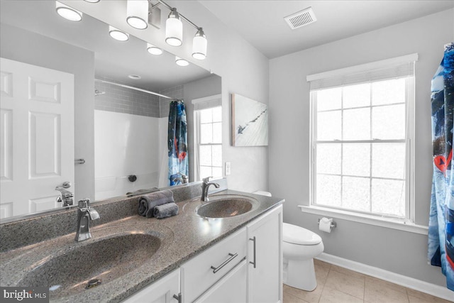 full bathroom featuring vanity, shower / bath combo, tile patterned floors, and toilet