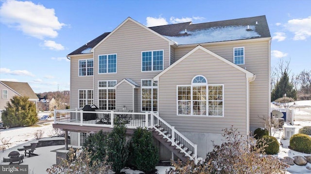 rear view of property with a wooden deck