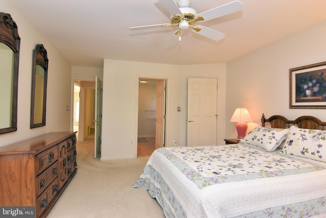 carpeted bedroom with ceiling fan and ensuite bath