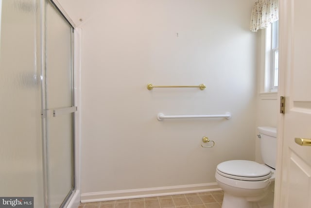 bathroom featuring walk in shower and toilet