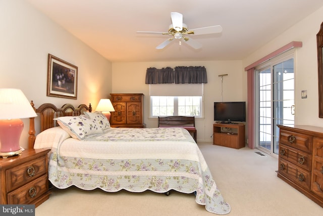 bedroom featuring light carpet, access to outside, and ceiling fan