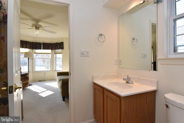 bathroom with ceiling fan, vanity, and toilet