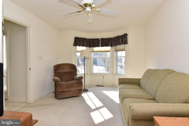 carpeted living room with ceiling fan