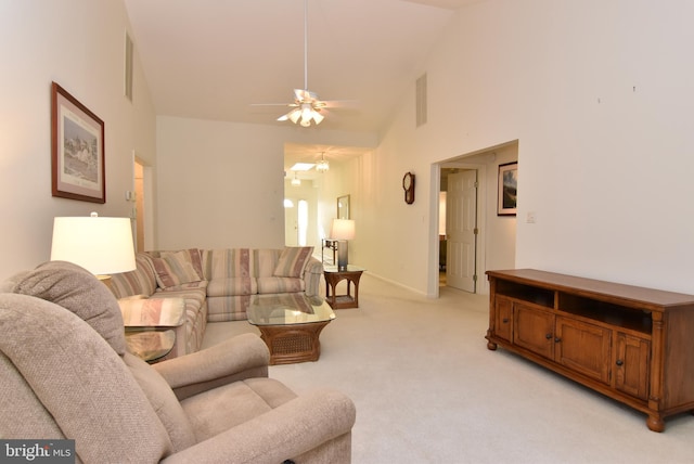 living room with ceiling fan, light colored carpet, and high vaulted ceiling