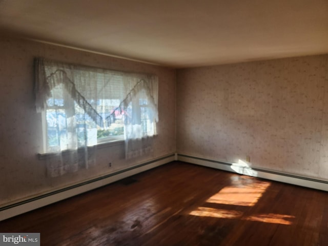 spare room featuring wood-type flooring