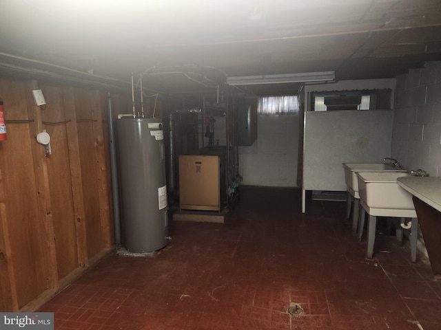 basement featuring water heater and wooden walls