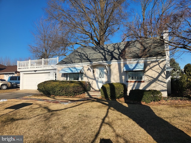 view of front of home with a garage and a front lawn