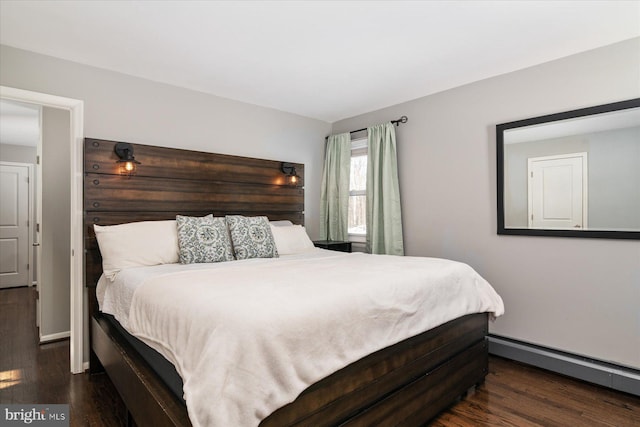 bedroom featuring dark hardwood / wood-style flooring and a baseboard heating unit