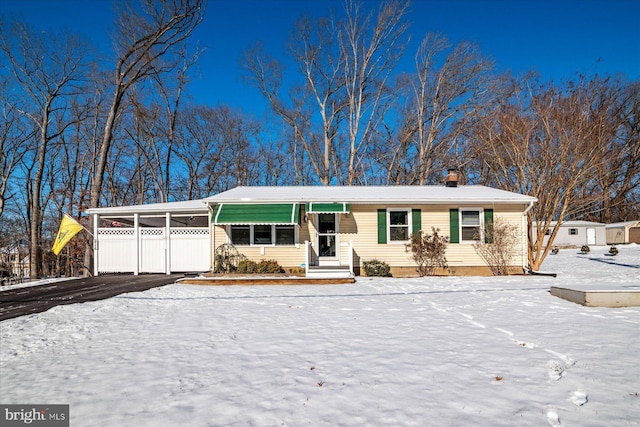 ranch-style home featuring a carport