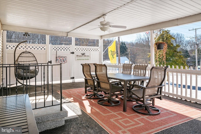 sunroom / solarium featuring ceiling fan