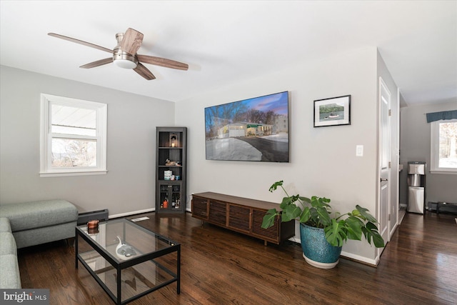 living room with ceiling fan, plenty of natural light, and dark hardwood / wood-style flooring