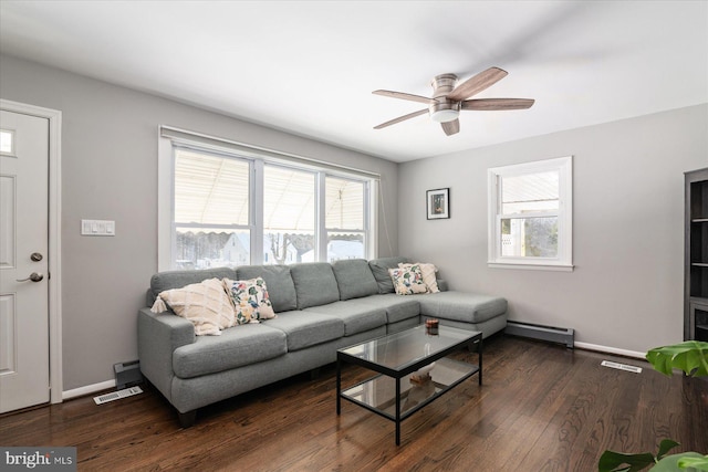 living room featuring baseboard heating, ceiling fan, and dark hardwood / wood-style floors