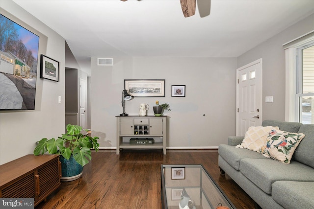 living room with dark hardwood / wood-style floors and ceiling fan