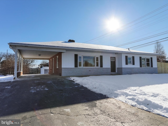 ranch-style house with a storage shed and a carport