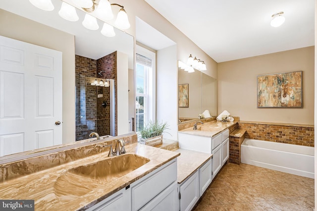 bathroom with a stall shower, a garden tub, two vanities, and a sink