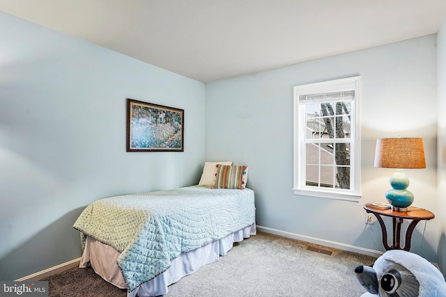 carpeted bedroom with visible vents and baseboards