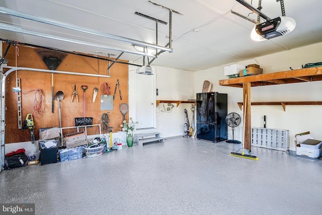 garage with freestanding refrigerator and a garage door opener