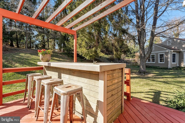 deck with a yard and outdoor dry bar