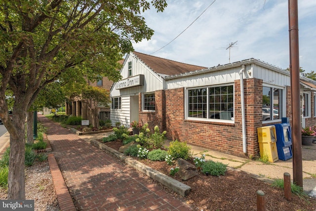 view of home's exterior featuring board and batten siding and brick siding