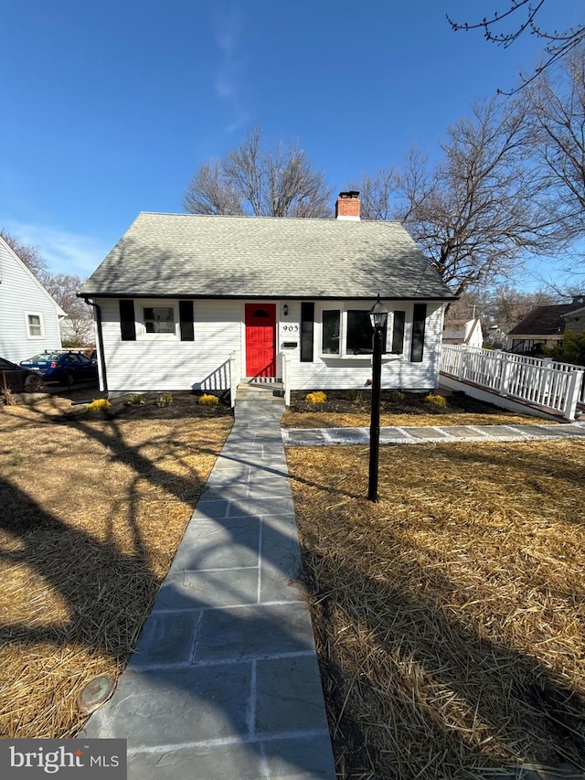 view of front of home featuring a shingled roof and a chimney