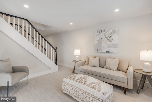 carpeted living room with baseboards, stairway, and recessed lighting