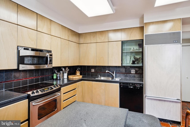 kitchen featuring decorative backsplash, sink, light brown cabinets, and appliances with stainless steel finishes