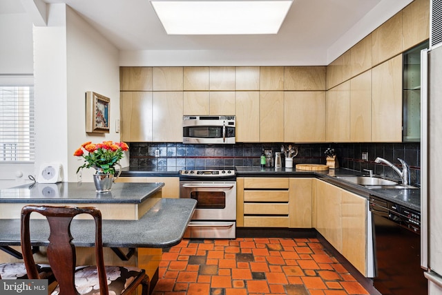 kitchen with light brown cabinetry, sink, stainless steel appliances, and tasteful backsplash