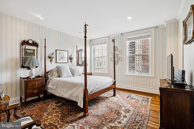 bedroom with hardwood / wood-style flooring and crown molding