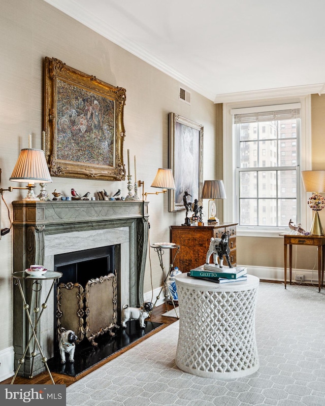 sitting room featuring a premium fireplace and crown molding