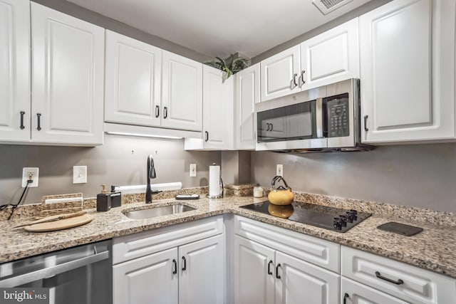 kitchen with white cabinetry, sink, and appliances with stainless steel finishes