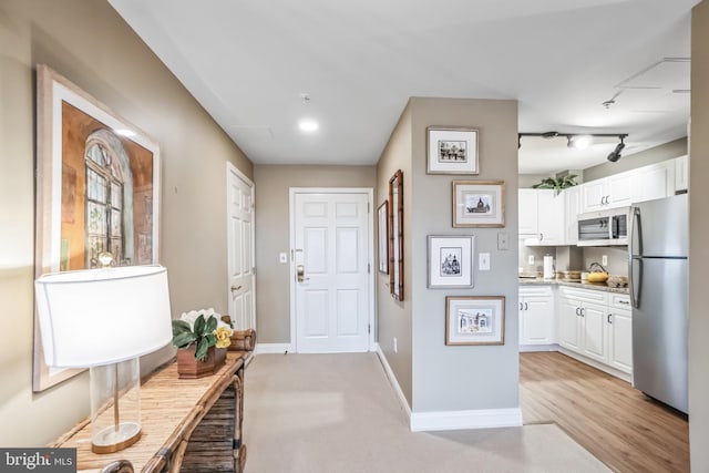 interior space featuring light carpet