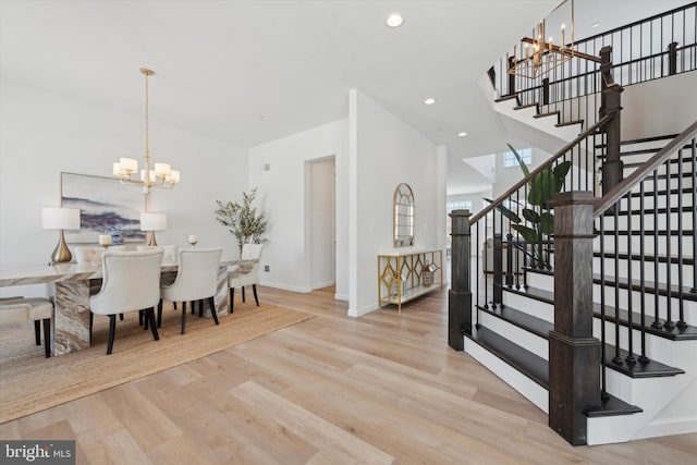 dining space with a chandelier and light hardwood / wood-style flooring