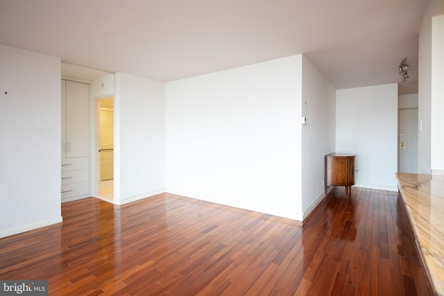 spare room featuring dark hardwood / wood-style flooring