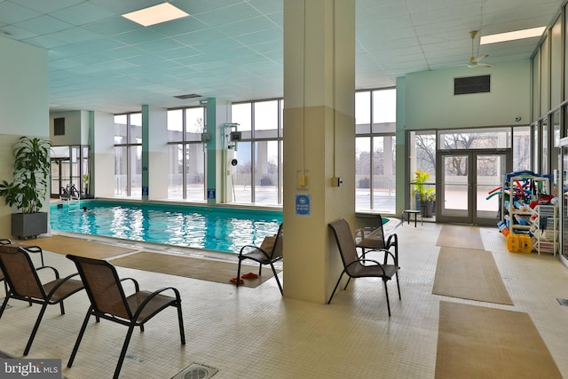 view of swimming pool with french doors