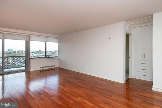 unfurnished room with dark hardwood / wood-style floors