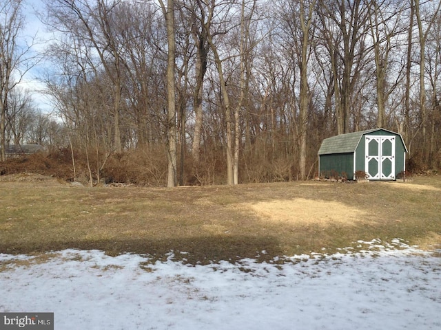 snowy yard with a shed