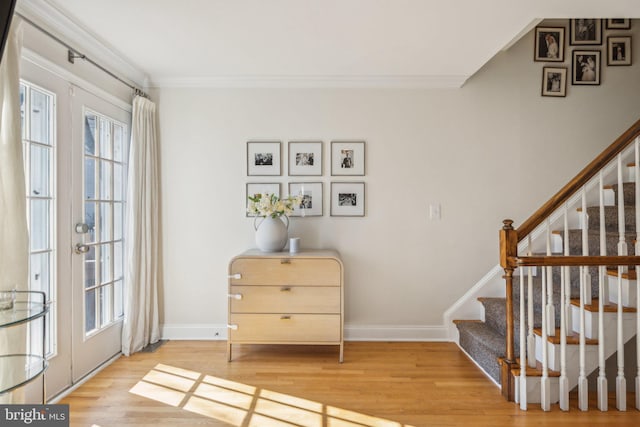 interior space featuring ornamental molding, hardwood / wood-style floors, and french doors