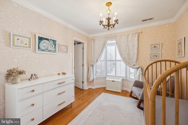 bedroom featuring crown molding, a chandelier, and light hardwood / wood-style floors