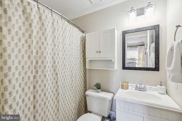 bathroom with ornamental molding, walk in shower, vanity, and toilet