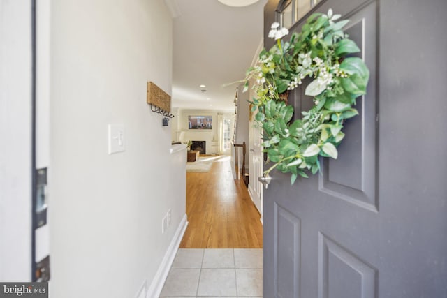 corridor featuring light tile patterned floors