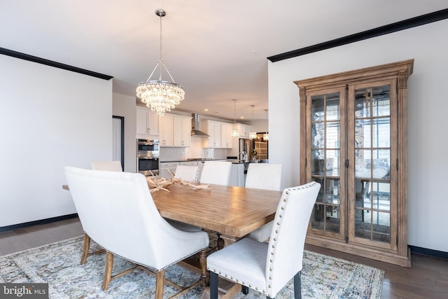 dining area with a notable chandelier, recessed lighting, baseboards, dark wood finished floors, and crown molding