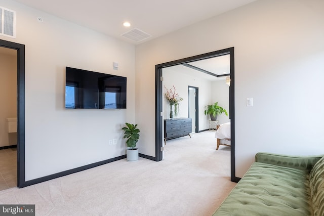 living room with recessed lighting, light colored carpet, visible vents, and baseboards